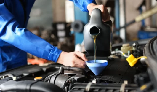 Oil change service at Fairview Tire AutoPro in Burlington - mechanic filling car's oil tank